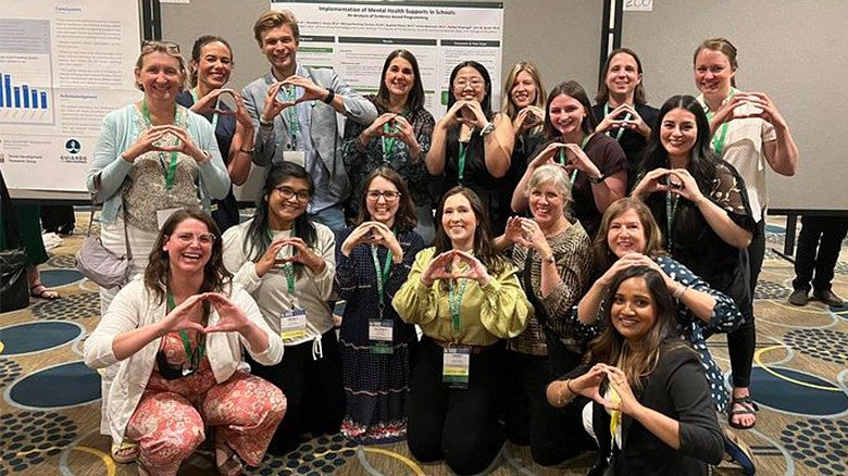 image of a group of Prevention Science institute students showing the Oregon O with their hands
