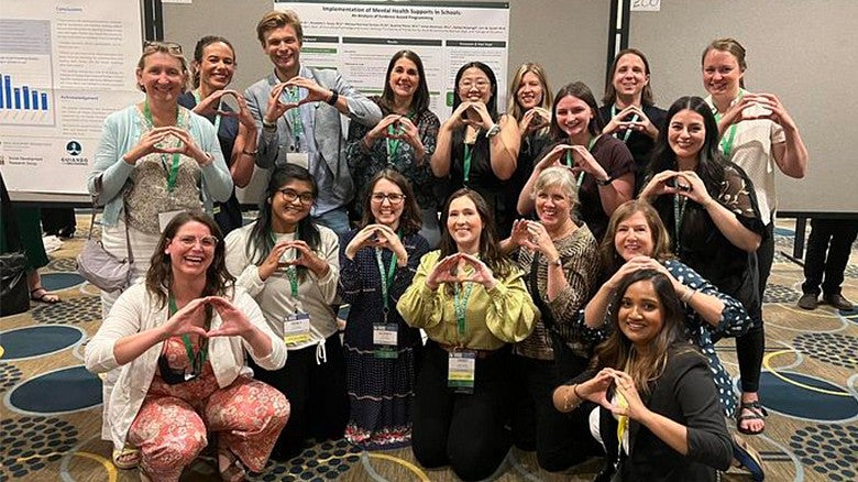 a group of Prevention Science institute students showing the Oregon O with their hands