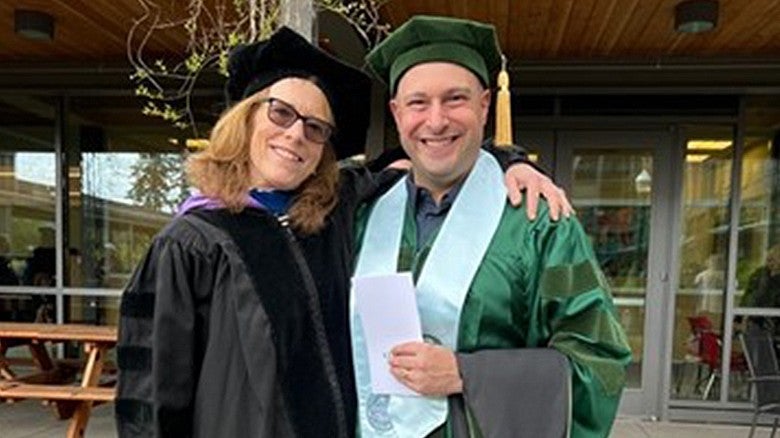 image of McKay Sohlberg, PhD with a student in regalia