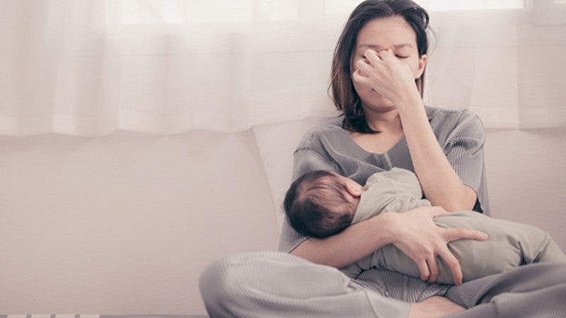 parent holding an infant on their lap