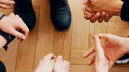 a group of individual hands clasped together
